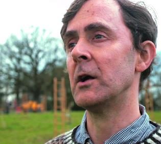 Finlay's face is photographed in front of an obstacle coarse