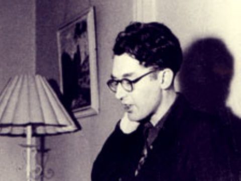 G.S. Fraser in his living room. Black and white