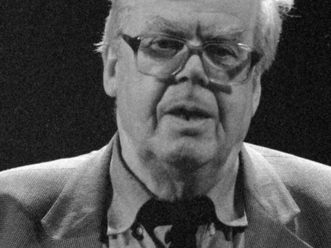 Derick Thomson in blacl and white giving a conference.